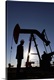 image thumbnail of Silhouette of oil worker by pump jack on rig