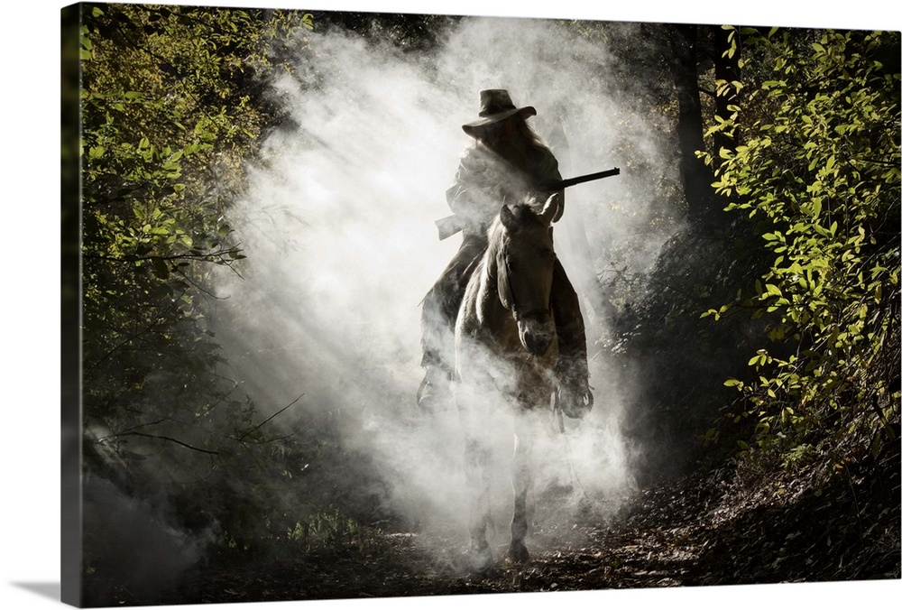 Bounty hunter, rider on the horse covered with smoke holding a gun