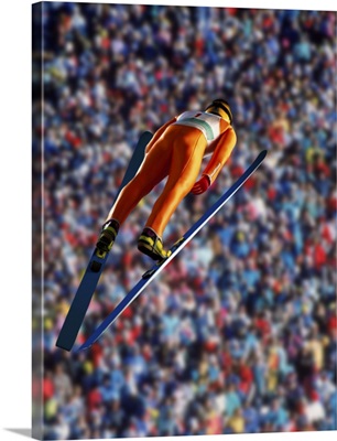 Ski jumper in mid-air jump, rear view