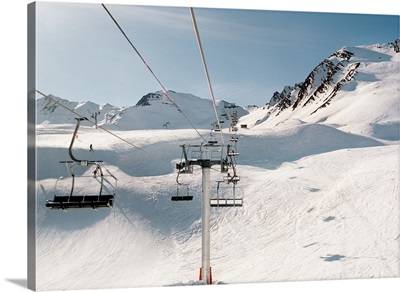 Ski lift in sunny snowy landscape