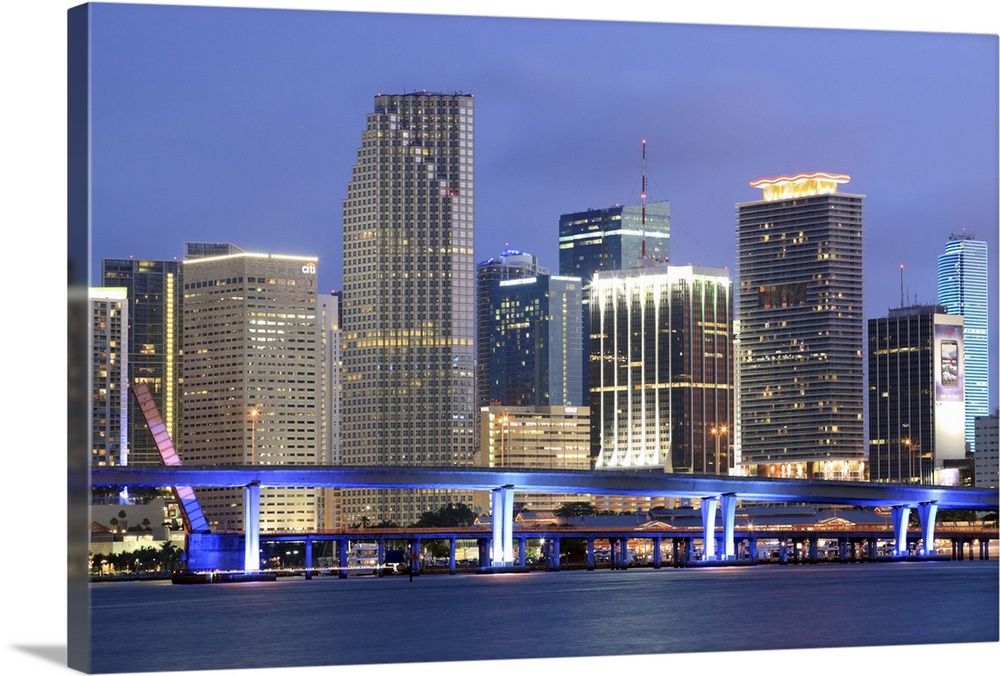 Large canvas photo art of the Miami cityscape lit up at night along the waterfront.