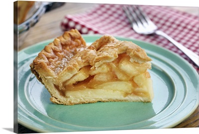 Slice of fresh baked apple pie on a green plate