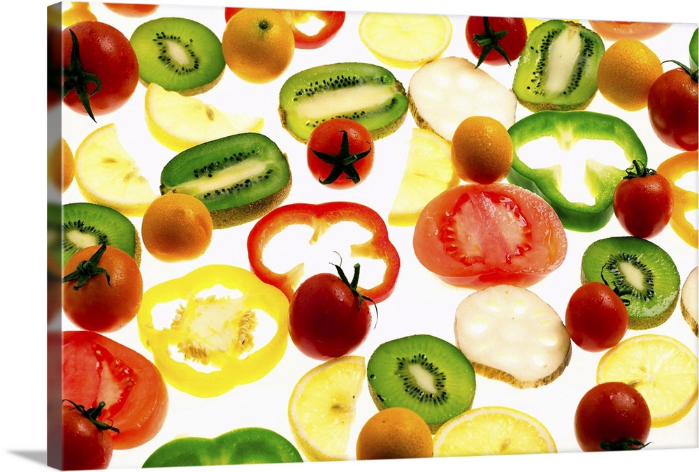 Sliced fruits and vegetables on illuminated white surface