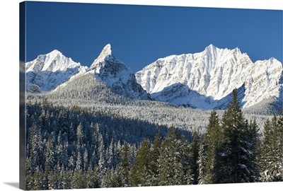 Snow covered mountain range against a deep blue sky, Canada
