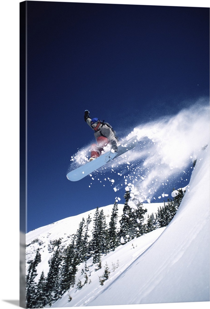 MALE SNOWBOARDER JUMPING IN TELLURIDE, COLORADO