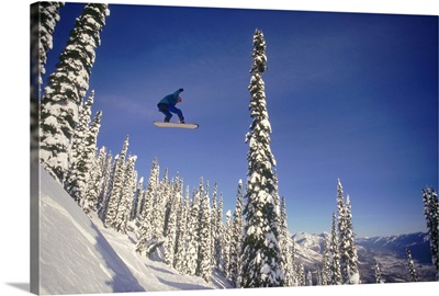 Snowboarding jumping through air , British Columbia , Canada