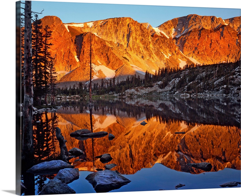 Evening light on the Snowy Range reflecting in Mirror Lake in Medicine Bow National Forest, Wyoming.