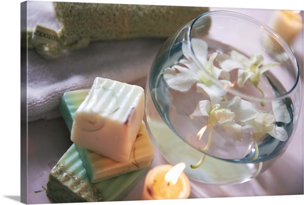 soaps with water bowl of orchids and candle in zen atmosphere
