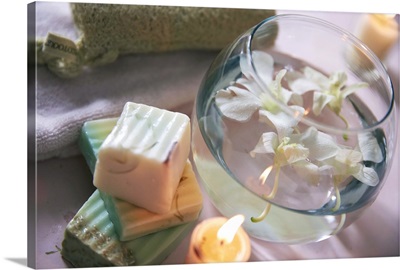 Soap bars with water bowl of orchids and candles