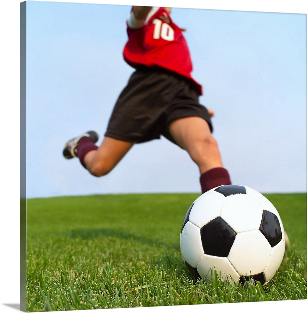 This is a square photograph of an athlete about to kick a ball.