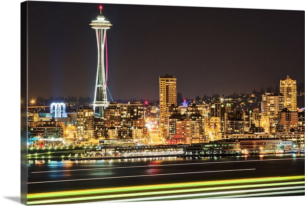 Space Needle with light trails from ferry in foreground at night