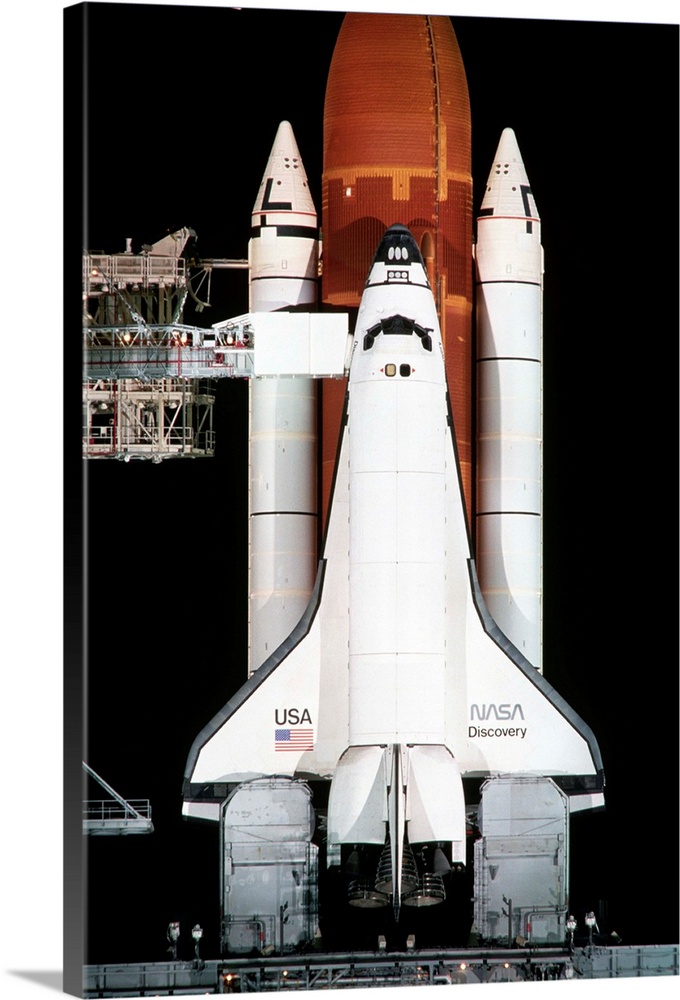 The space shuttle Discovery sits on the launch pad on the eve of the launch of Space Shuttle Mission 26.