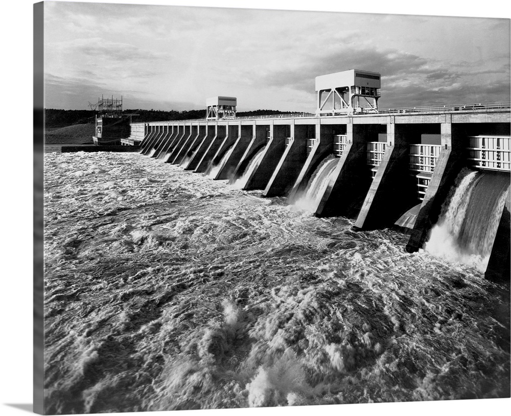 Water pours from open spillways at the Pickwick Landing Dam, a project of the Tennessee Valley Authority. Officials were c...
