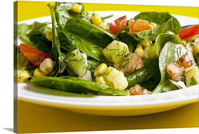 Spinach and sweet corn salad with tomatoes, cucumber and dill