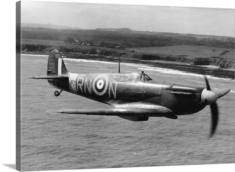 A Spitfire in flight of the coast of Britain during World War II.