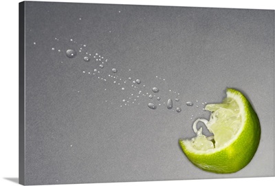 squeezed lime wedge with spray droplets