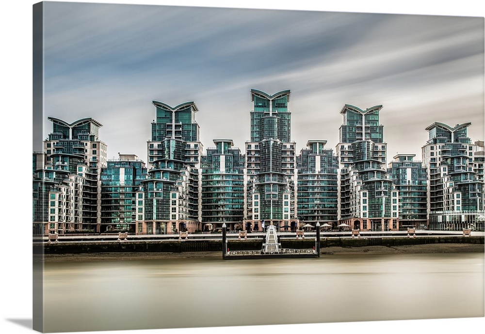 Long exposure of the five ultra modern towers of Saint Georges Wharf, with the rives Thames in the foreground and dramatic...