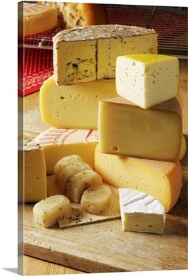 Stack of various cheese on chopping board