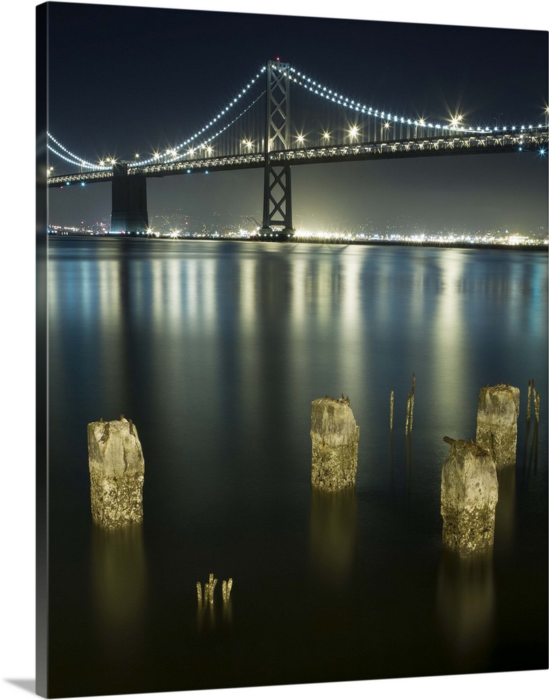 Pilings along the Embarcadero, San Francisco, looking out towards the Bay Bridge and over to Oakland.