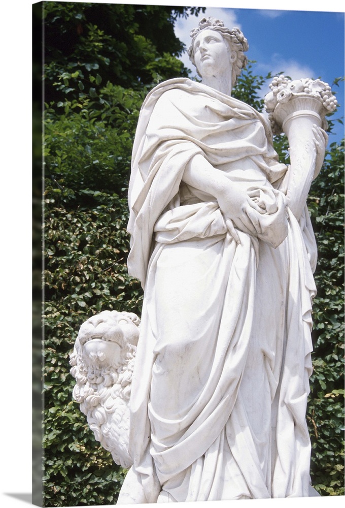 Statue in the garden of a woman holding a cornuccpoia