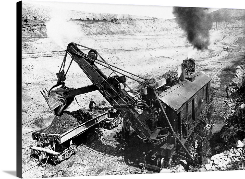 A railroad steam shovel loads a flat car in a open pit copper mine, Santa Rita, New Mexico. | Location: Santa Rita, New Me...