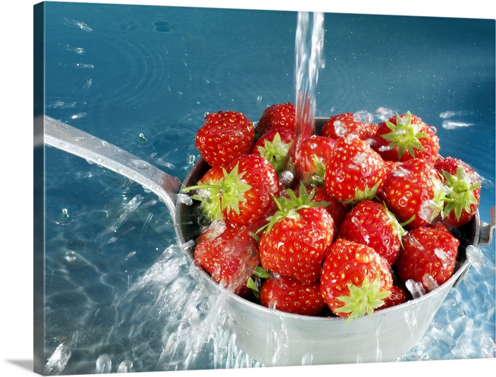 Strawberries washing in sieve, close-up