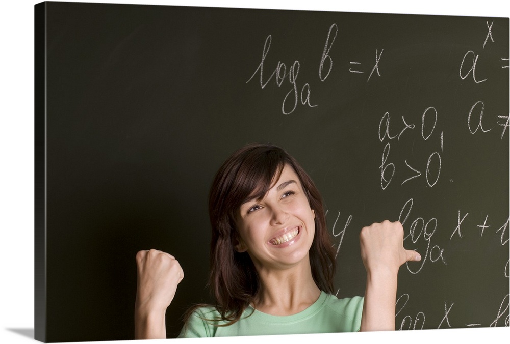 portrait of happy female student in front of blackboard