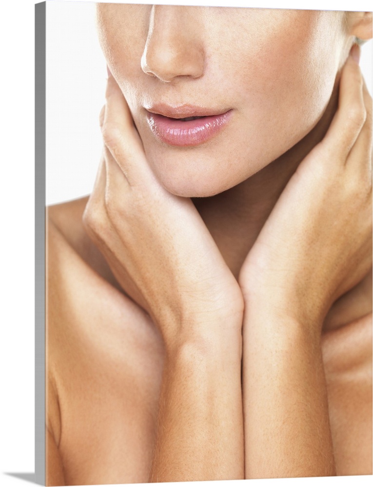 Studio portrait of beautiful woman with hands over neck