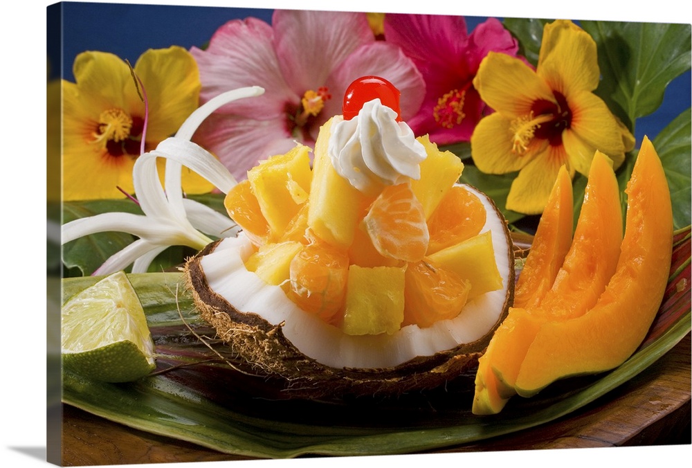 Studio shot of a tropical fruit salad with flowers.