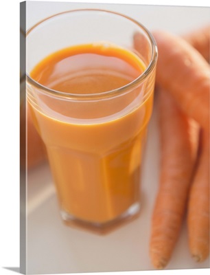 Studio shot of carrots and carrot juice
