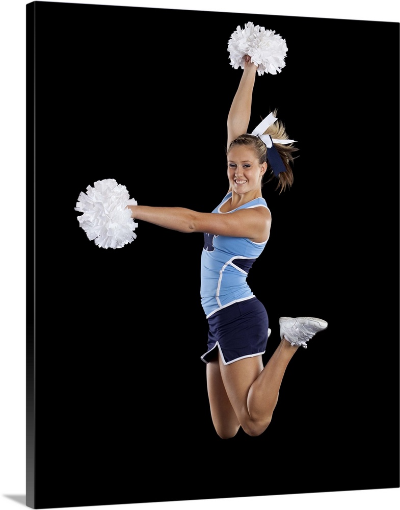 Studio shot of cheerleader (16-17) jumping