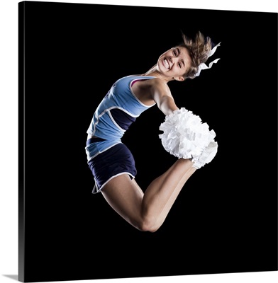 Studio shot of cheerleader jumping