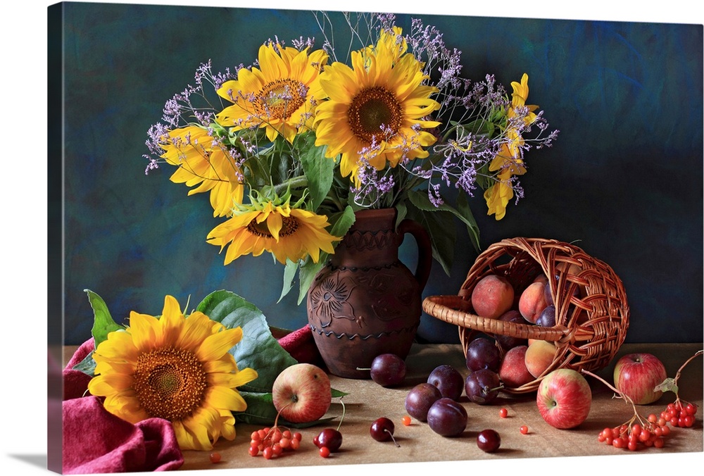 Big photograph composed of a flower arrangement sitting within and around a ceramic jug that is next to an assortment of f...