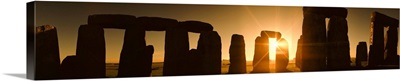 Sun rising over Stonehenge rock formation