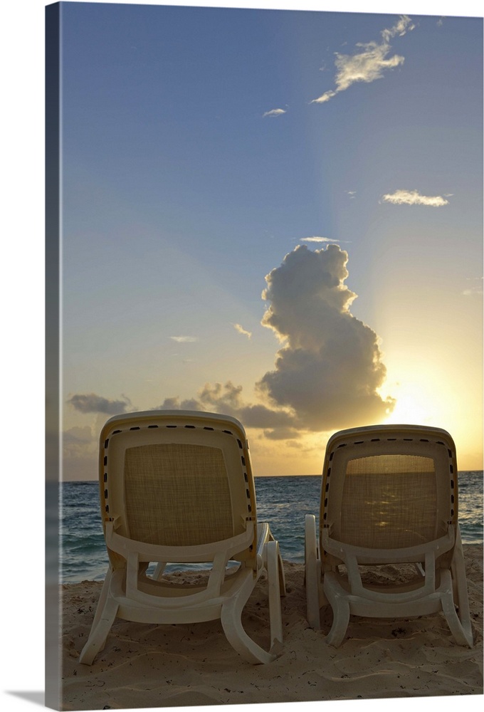 Sunloungers on a tropical beach at sunrise