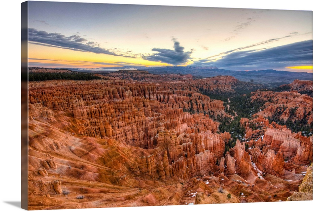 A moody sunrise at Inspiration Point in Bryce Canyon National Park still manages to reveal the deep red colors of the colo...