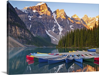 Sunrise on Moraine Lake and colorful canoes, Canada