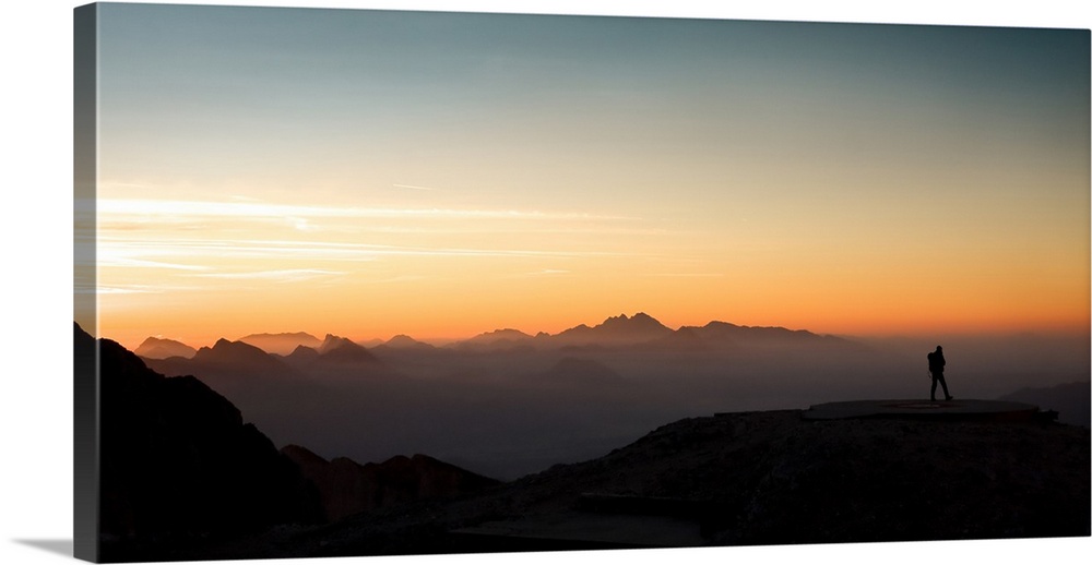 Mountaineer looking at the sunrise.