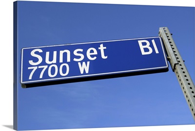 Sunset Boulevard sign against a blue sky from a low angle.