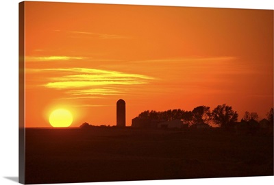 Sunset in rural landscape with silo