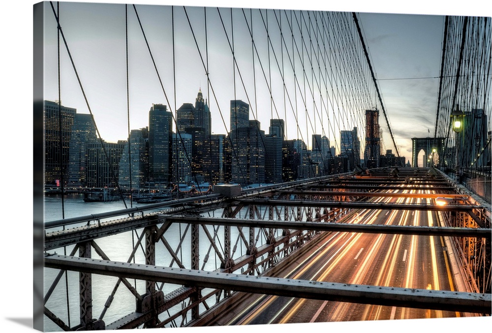 Sunset over the Brooklyn Bridge facing Manhattan during rush hour.