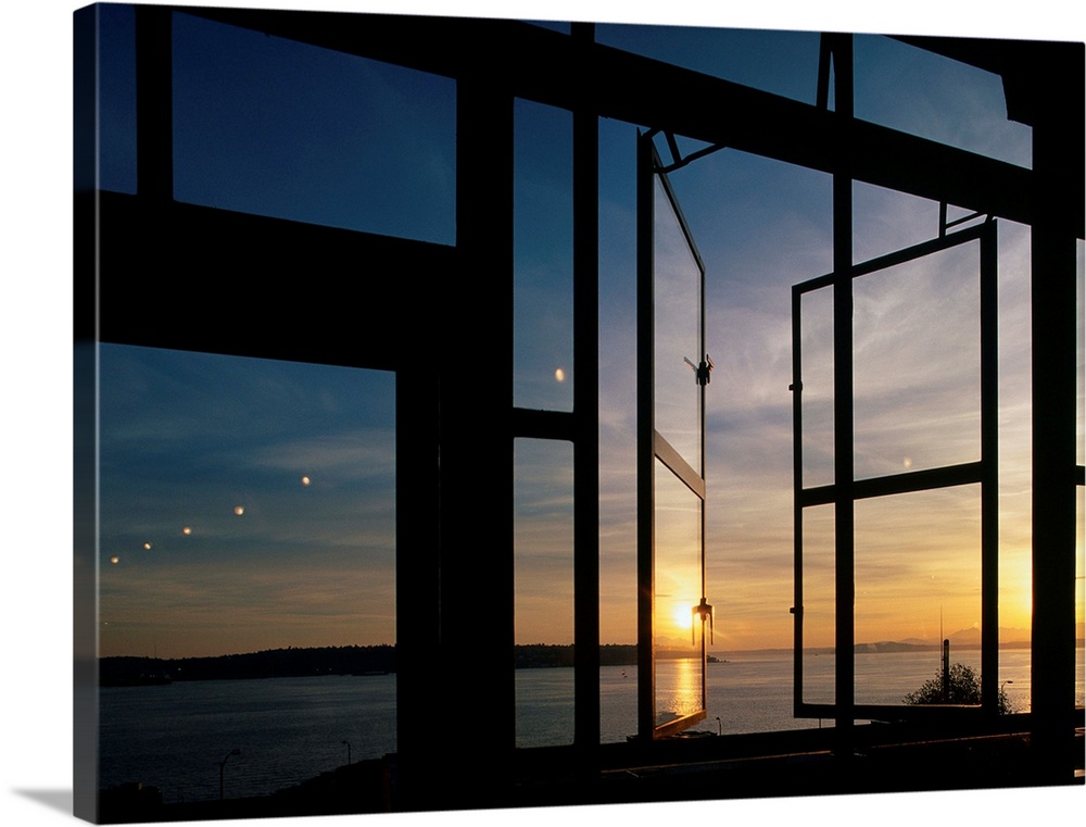 A summer sunset is reflected on glass windows at Seattle's Pike Place Market.