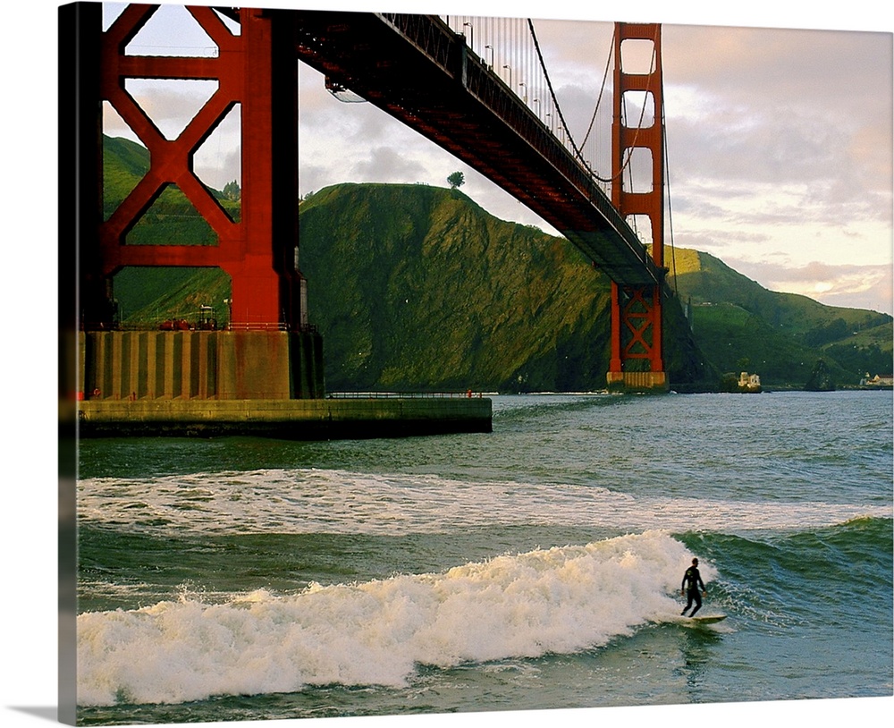 Taking advantage of an evening ebb tide, he rides in the cove close to Fort Point, part of the Presidio and the Golden Gat...