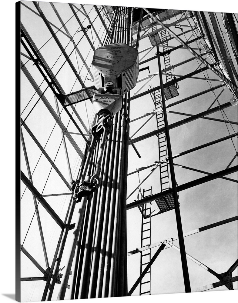 View of a Superior Oil Co. wildcat well at Pacific Creek, Wyoming. Shows the draw-works of the 150-foot drilling rig. Unda...