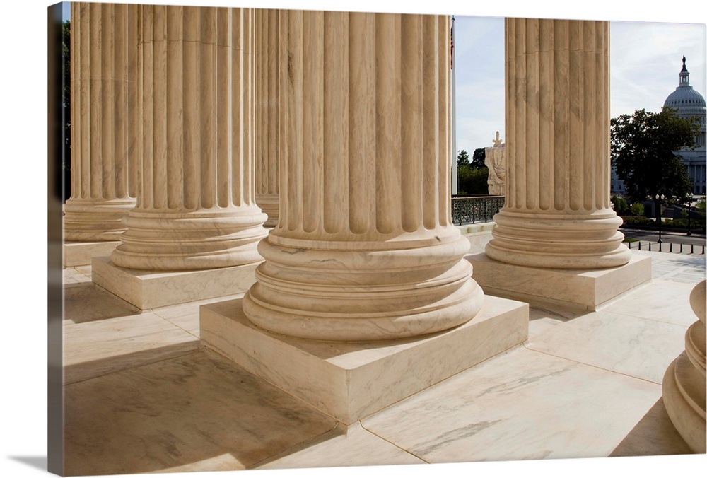 USA, District of Columbia, Washington, DC, Columns at entrance to Supreme Court Building and Capitol Building in distance.