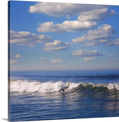 Surfer riding big wave in Ocean beach, California.