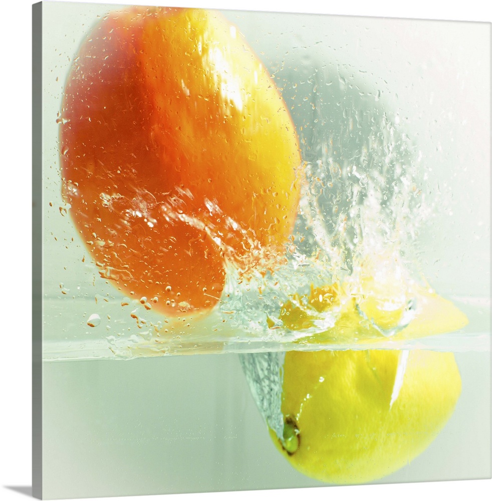 an orange and a lemon dropped in water and captured during a splash. color and square format image