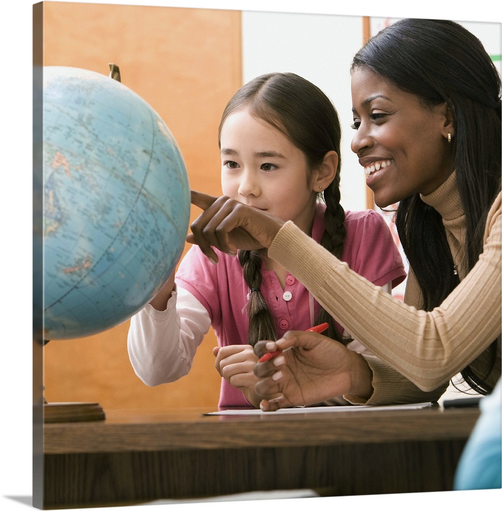 Teacher and student looking at globe