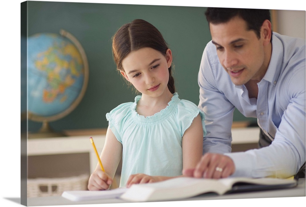 USA, New Jersey, Jersey City, teacher helping schoolgirl (8-9)