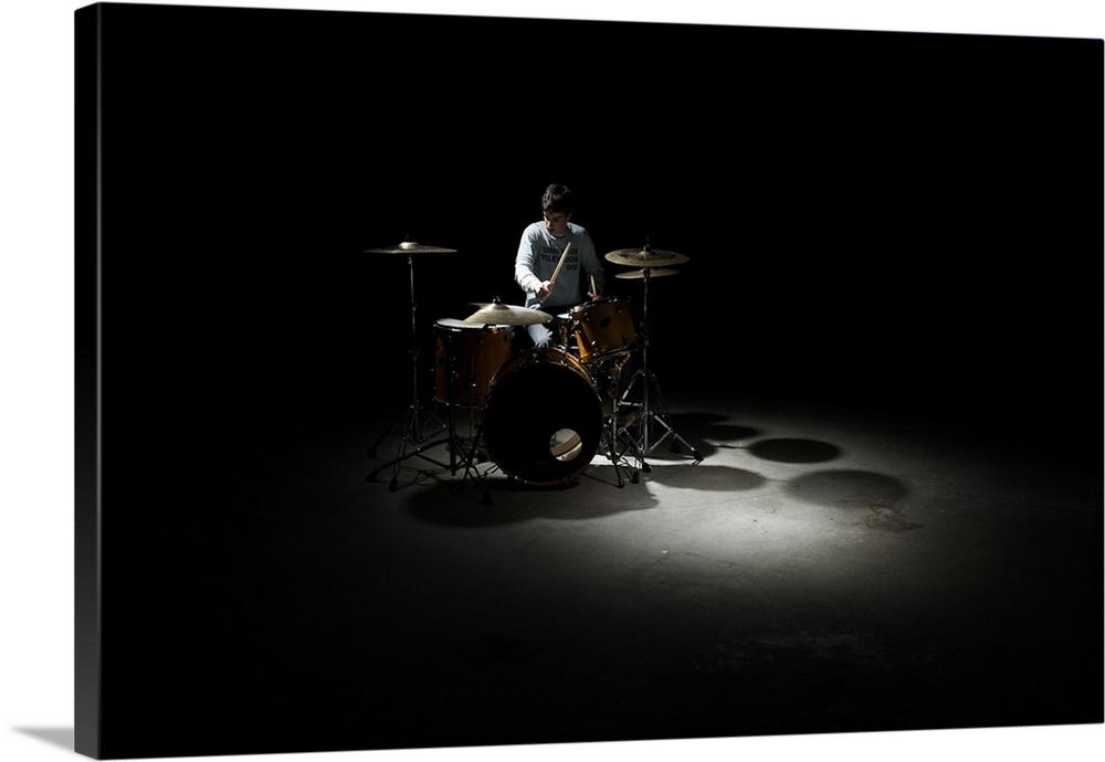 Teenage boy (13-15) playing drums
